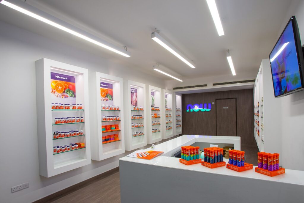 NOW Foods products displayed on illuminated shelving inside the Limassol store